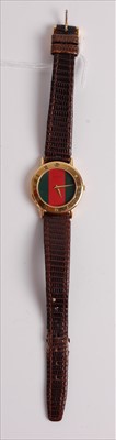 Lot 473 - A Gucci lady's gold plated quartz wristwatch,...