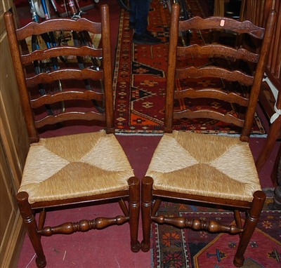 Lot 1298 - A set of six contemporary oak ladderback rush...