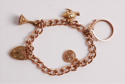 Lot 478 - A 9ct gold charm bracelet, containing a small...