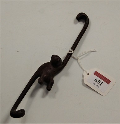 Lot 651 - An iron swinging monkey figure, 21cm