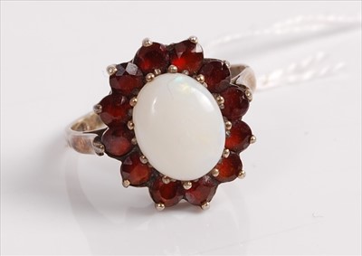 Lot 490 - A silver gilt, opal and garnet set dress ring,...