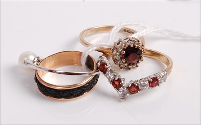 Lot 503 - A 9ct gold, garnet and cz set wishbone ring;...