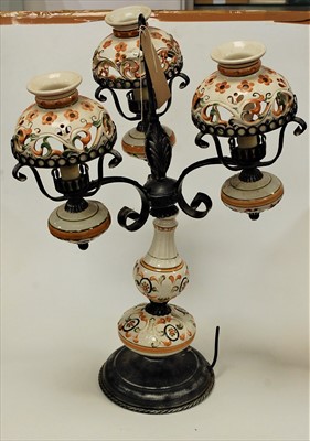 Lot 107 - A continental pottery three branch table lamp