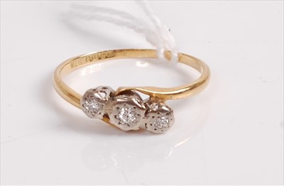 Lot 509 - An 18ct gold and diamond three stone ring, the...