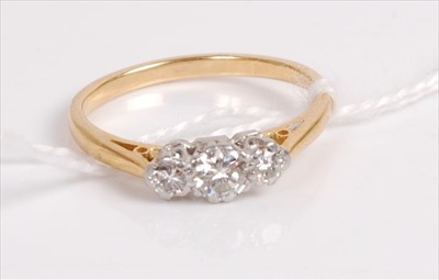 Lot 526 - A yellow metal diamond three stone ring, the...