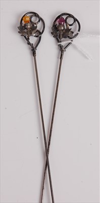 Lot 528 - A pair of white metal hat-pins, each set with...