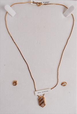 Lot 532 - A modern 9ct gold pendant, set with a diamond...