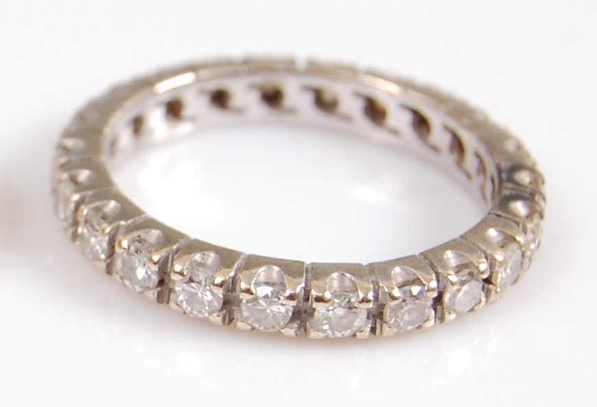 Lot 2004 - A white metal diamond full hoop eternity ring,...