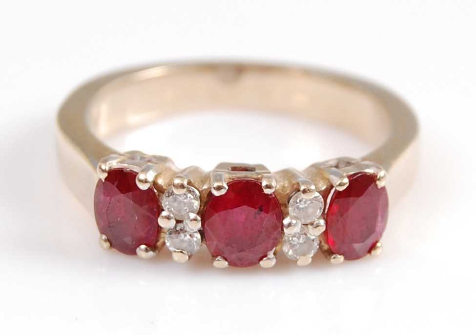 Lot 2066 - A yellow metal, ruby and diamond seven stone...