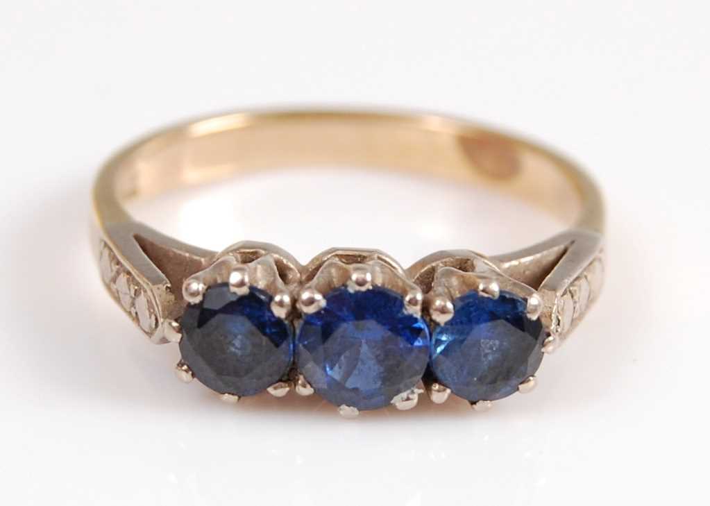 Lot 2068 - A yellow and white metal sapphire three stone...