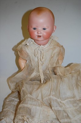 Lot 2121 - A German bisque head doll, having rolling blue...