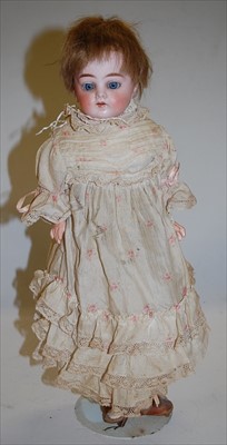 Lot 2125 - An unmarked bisque head doll, having rolling...