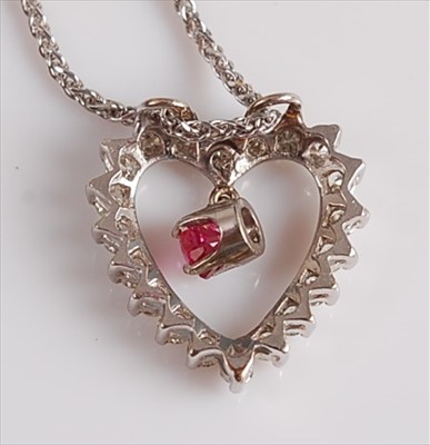 Lot 2106 - A white metal, ruby and diamond heart shaped...