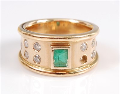 Lot 2107 - A yellow metal, emerald and diamond dress ring,...