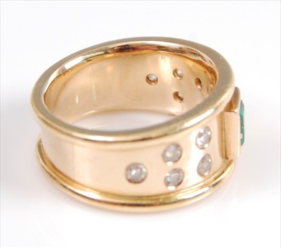 Lot 2107 - A yellow metal, emerald and diamond dress ring,...