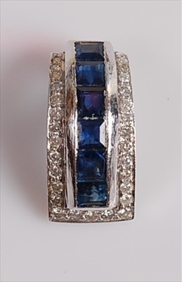 Lot 2105 - A white metal, sapphire and diamond pendant...