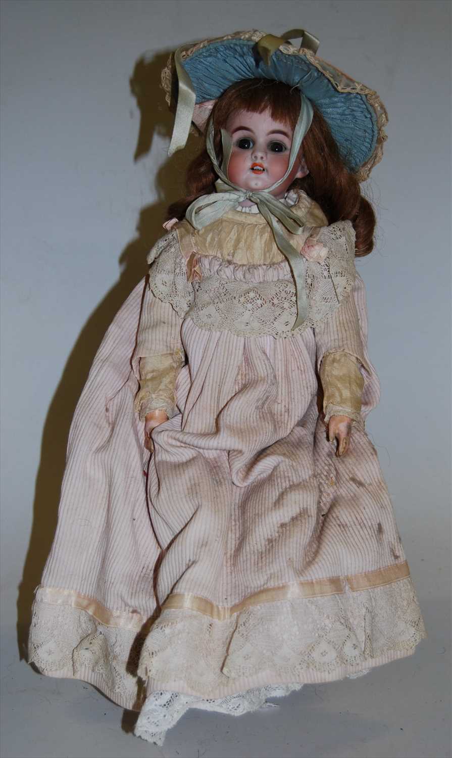Lot 2145 - An unmarked bisque head doll, having rolling...