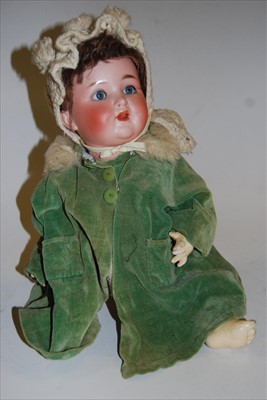 Lot 2152 - A German bisque head doll, having rolling blue...