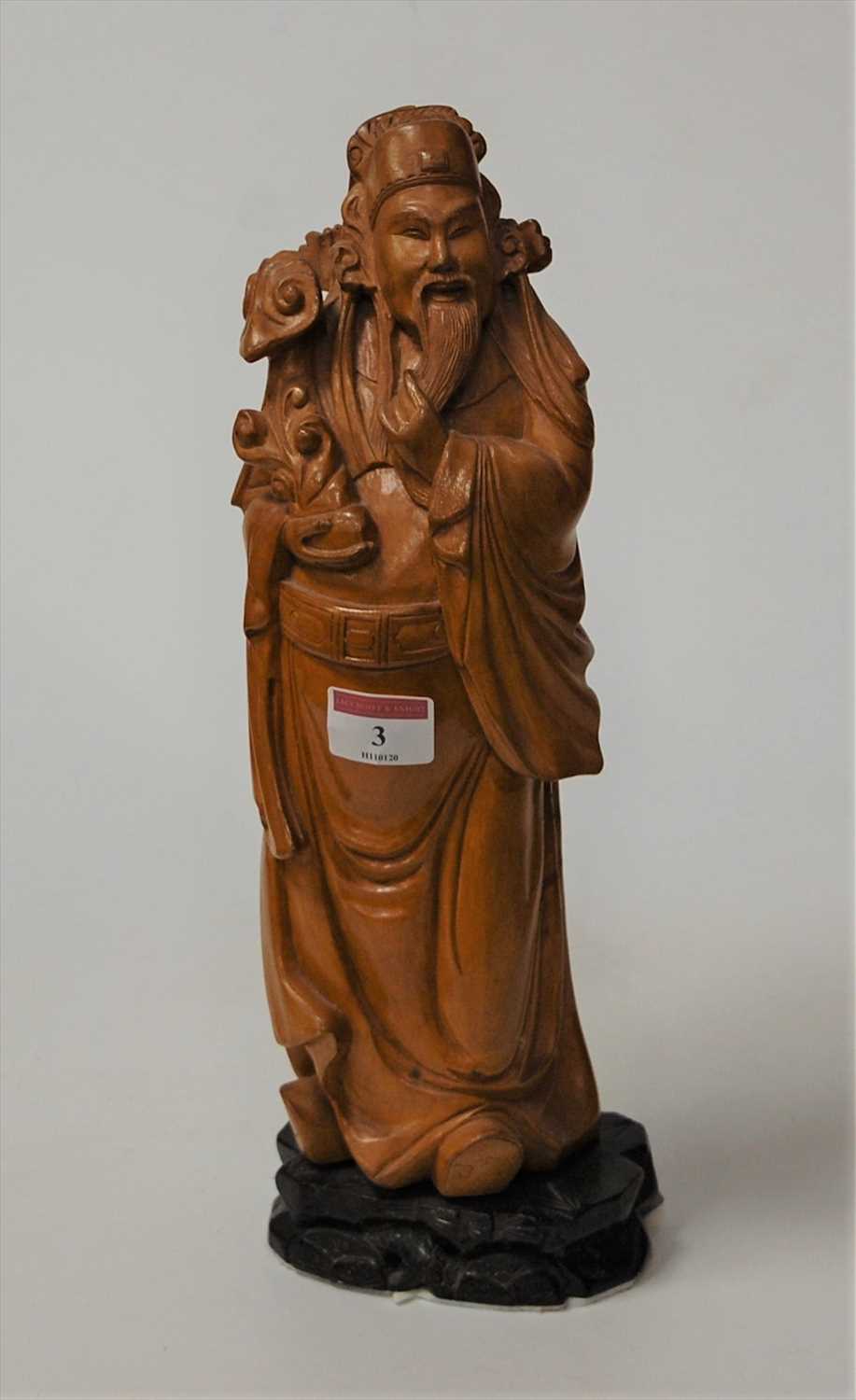 Lot 3 - An Oriental hardwood carving of a scholar, on...