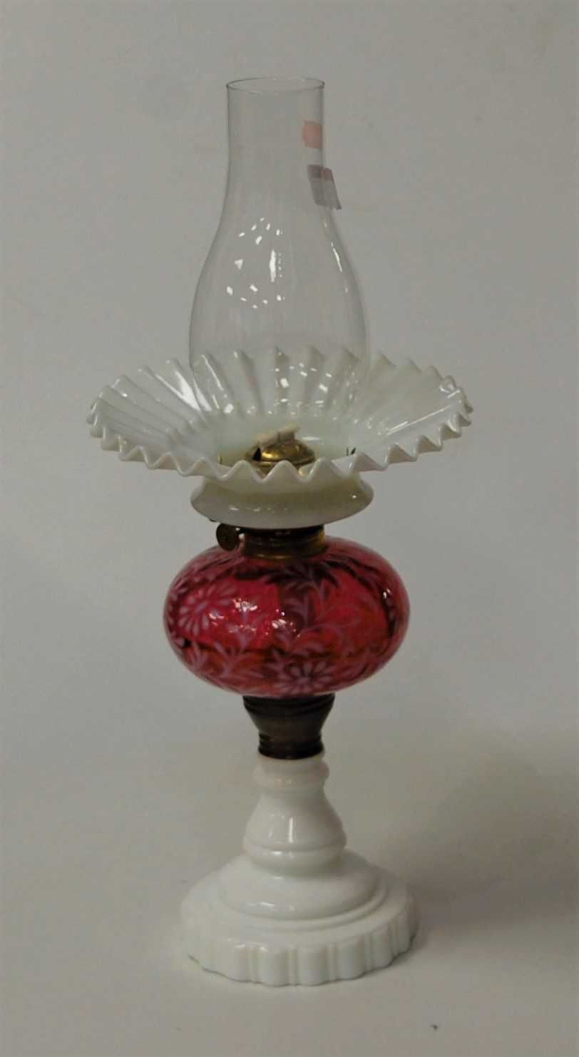 Lot 13 - An opaline glass pedestal oil lamp, having...