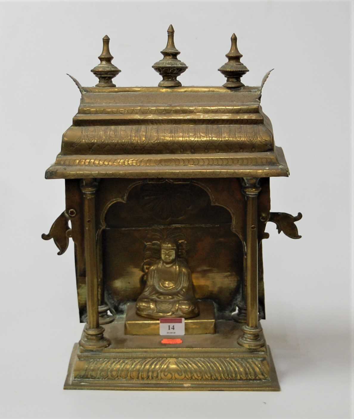 Lot 14 - An Eastern brass pagoda with inset deity, h.42cm
