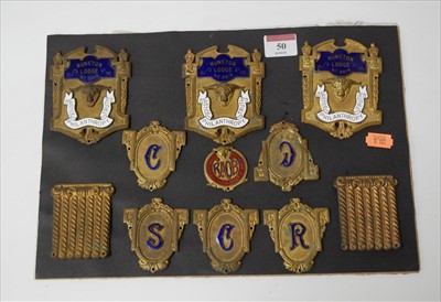 Lot 50 - A display of pressed brass and enamel masonic...