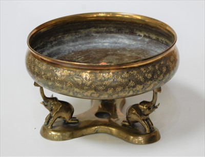 Lot 140 - An eastern brass bowl on triform elephant...