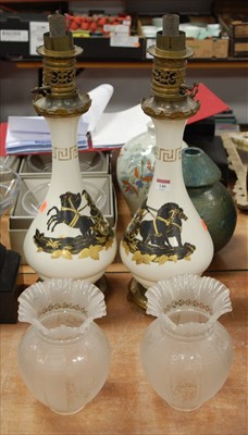 Lot 146 - A pair of porcelain oil lamps each decorated...