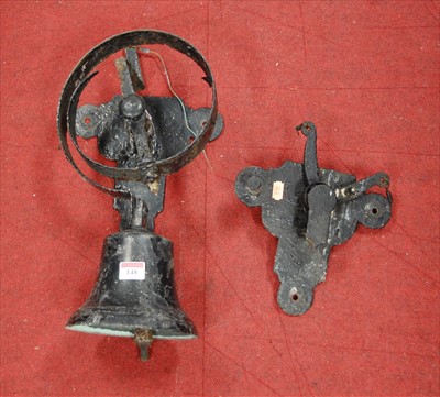 Lot 148 - A cast iron exterior bell on sprung wall mount,...