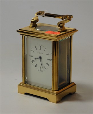 Lot 215 - A reproduction lacquered brass carriage clock,...
