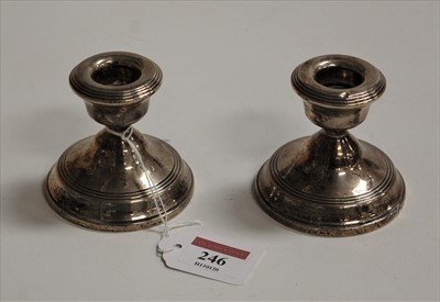Lot 246 - A pair of silver dwarf candlesticks, on loaded...