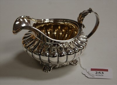 Lot 253 - A George IV silver cream jug, of reeded squat...