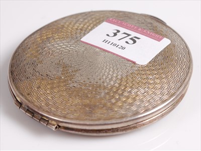 Lot 375 - A lady's silver powder compact, having engine...