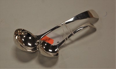 Lot 301 - A modern sauce ladle; together with one other...