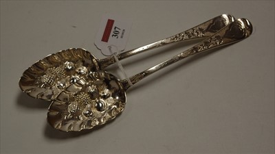 Lot 307 - A pair of George III silver berry spoons,...