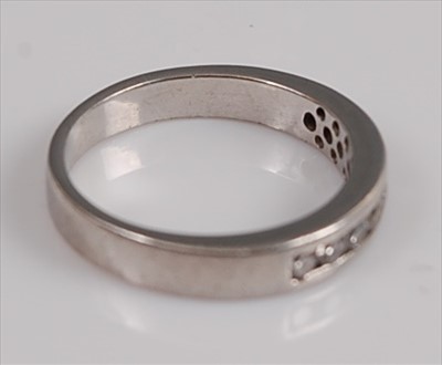 Lot 1204 - A platinum diamond half-hoop eternity ring,...