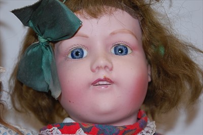 Lot 2170 - A German bisque head doll, having rolling blue...