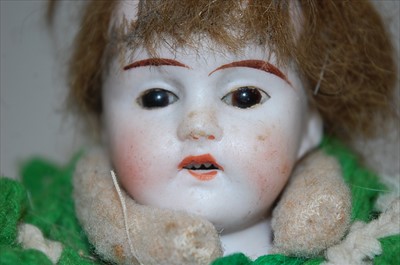 Lot 2222 - An unmarked German bisque head doll, having...