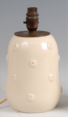 Lot 35 - An Art Deco cream painted table lamp by Susie...