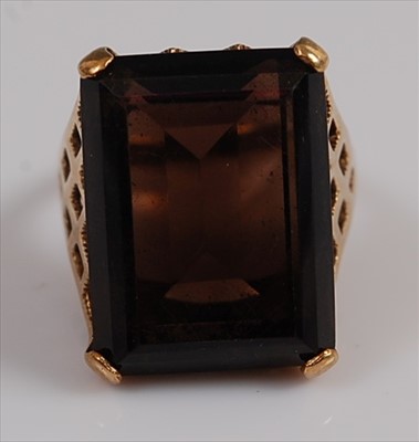 Lot 2144 - A 9ct yellow gold smoky quartz dress ring...