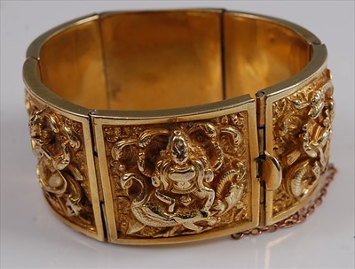 Lot 1213 - A yellow metal Asian style panel bangle,...