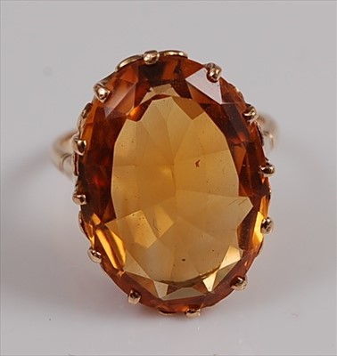 Lot 2146 - A yellow metal citrine dress ring, the oval...