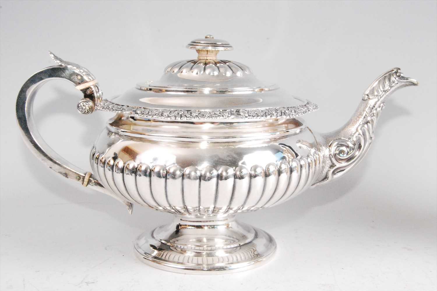Lot 1139 - A George IV silver pedestal teapot, having...