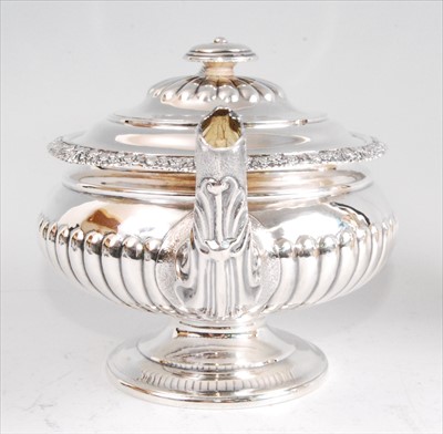 Lot 1139 - A George IV silver pedestal teapot, having...