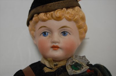 Lot 2254 - A bisque head doll, having moulded light brown...