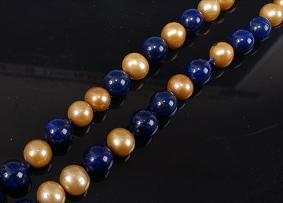 Lot 2149 - An opera length pearl and lapis lazuli...