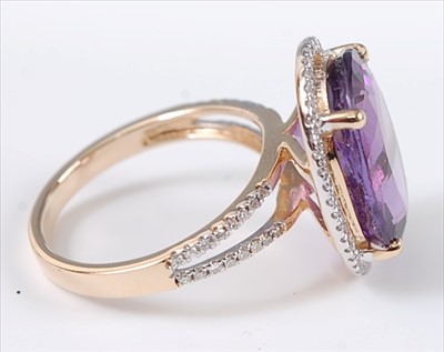 Lot 1227 - A yellow metal, amethyst and diamond oval...