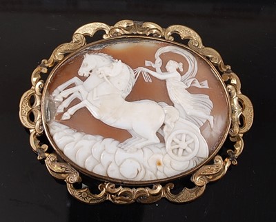 Lot 2154 - A large carved shell cameo brooch in yellow...