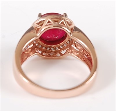 Lot 1229 - A rose gold, ruby and diamond circular cluster...