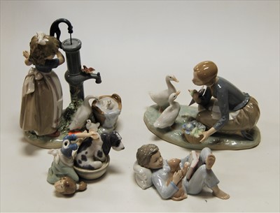 Lot 32 - A Lladro porcelain figure group of a young...
